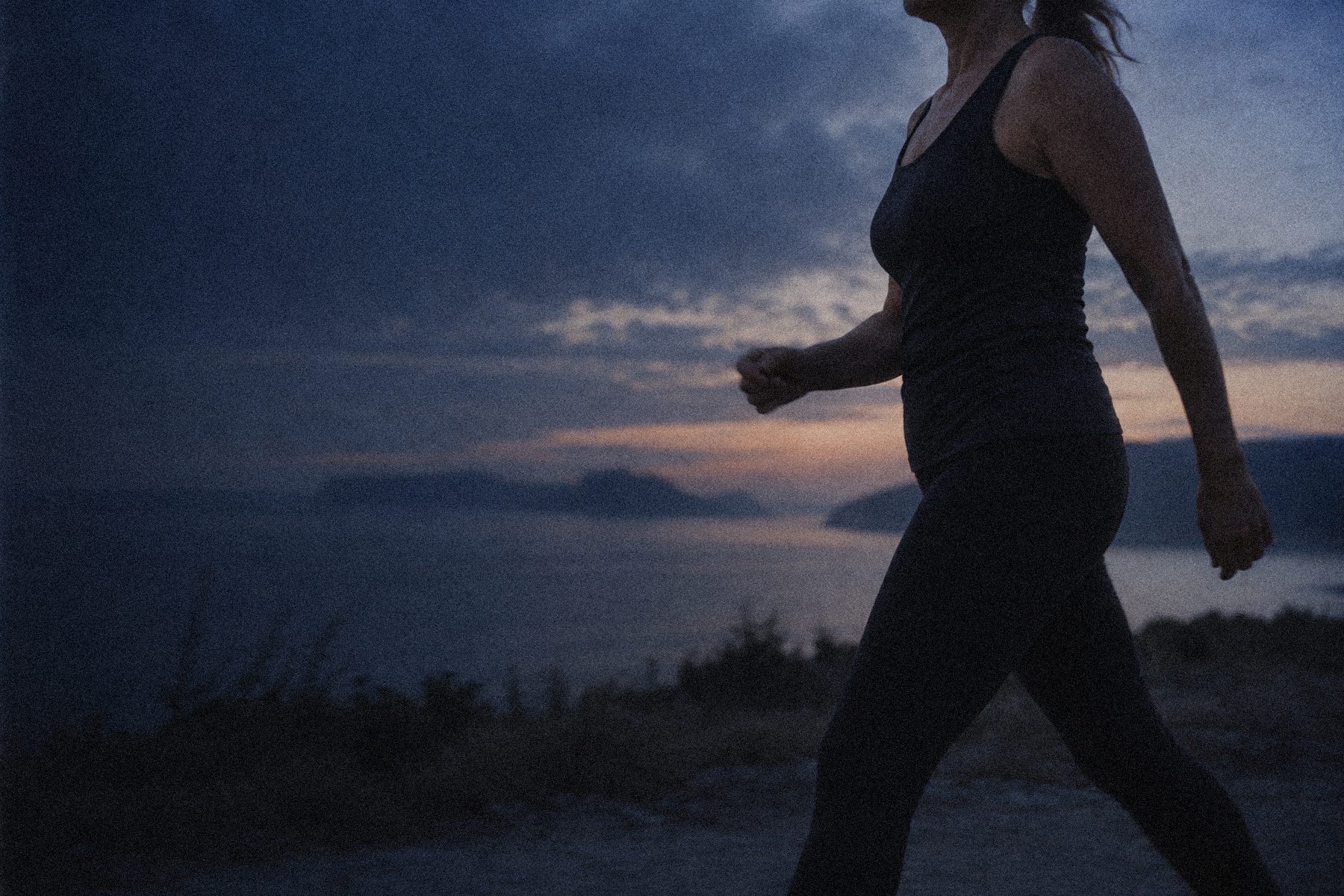 Woman walking outdoors at dusk